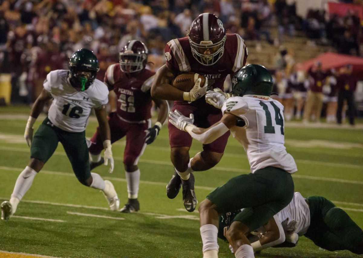 Picayune running back Dante Dowdell (2) jumps through West Point's Chris Chandler (14) and into the end zone for a touchdown during the first quarter of the MHSAA Class 5A football championship game.